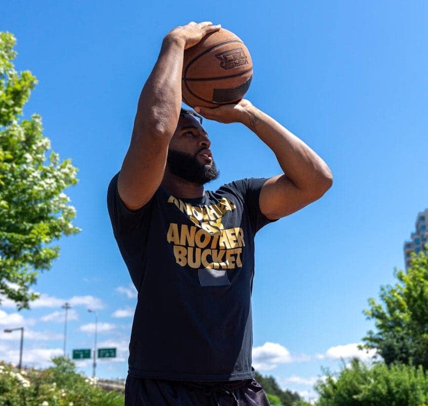 Left handed man shooting a basketball